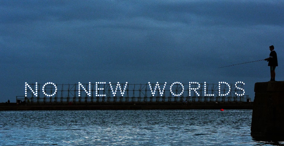 The illuminated sign on Mount Batten pier spelling out 'No New Worlds'
